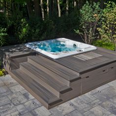 a hot tub sitting on top of a wooden deck