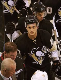 an image of a hockey player getting ready to play the game in front of other players