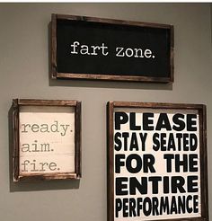 two framed signs on the wall that say, please stay seated for the entire performance