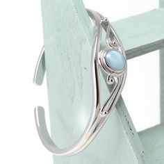 "Material:100% 925 Sterling Silver with White Gold Plated Main stone:Larimar Gemstone Other stone:N/A Size:2.32\" x 1.85\" Condition:New Main color:Blue Quantity:1 Pcs This bracelet is made with 100% natural genuine rare Larimar stone from Dominican Republic and solid 925 sterling silver w/ Rhodium gold plating for better quality and prolonged shine! Please check my other beautiful silver jewelry: www.etsy.com/shop/Chainstones A lab grown gem is a man-made material with essentially the same chem Elegant Turquoise Larimar Jewelry, Elegant Larimar Bracelet Jewelry, Elegant Round Larimar Jewelry, Elegant Larimar Cabochon Jewelry, Larimar Bracelet Jewelry Gift, Elegant Turquoise Larimar Bracelets, Silver Larimar Bracelets As Gift, Elegant Turquoise Sterling Silver Oyster Bracelet, Elegant Turquoise Gemstone Sterling Silver Bracelet