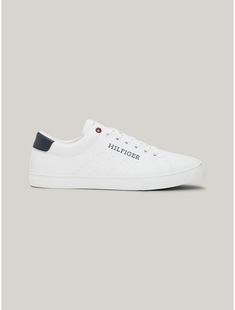 Tommy Hilfiger men's sneaker. The bold, yet streamlined design of these low-cut sneakers make them the pair you'll wear time and again.  Material: 69% Polyurethane, 31% Polyesther Pes. Tommy Hilfiger Lace-up Sneakers With Embossed Logo, Tommy Hilfiger Leather Sneakers For Streetwear, Sporty Tommy Hilfiger Sneakers With Embossed Logo, Tommy Hilfiger Sporty Sneakers With Embossed Logo, Tommy Hilfiger Low-top Sneakers With Embossed Logo, Sporty Slip-on Sneakers With Logo Print, Low-top Synthetic Sneakers With Logo Print, Low-top Sneakers With Logo Print, White Sole Synthetic Sneakers With Logo Print