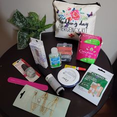 the contents of a travel bag sitting on top of a table next to a potted plant