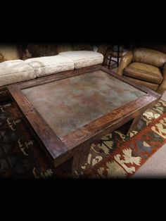 a coffee table sitting on top of a rug in a living room