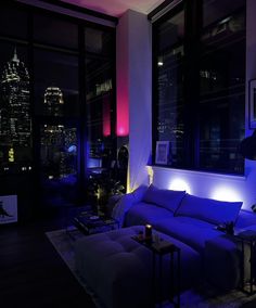 the living room is lit up with blue lighting