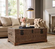 a living room with a couch, coffee table and fire place