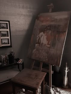 an old easel sitting in front of a painting