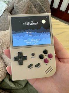 a person is holding an old nintendo gameboy