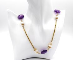 Necklace jewelry.  Amethyst and pearl Necklace with gold chain.  Handmade gemstone and gold bead caps on long necklace jewelry. Anniversary, birthday and graduation necklace jewelry.  An ideal gift for her. MATERIALS AND SIZE 20mm amethyst coin shape beads 10mm and 88mm white shell pearl beads 18k gold over stainless steel oval linked chain 18k gold over stainless steel jump rings 18k gold over stainless steel lobster claw clasp Gold wire bead caps (handmade) Necklace measures - -41 inches in length    Can be worn long as is or worn doubled up.   Fit for any occasion. Gold Single Strand Necklace As A Gift, Gold Single Strand Long Necklace As Gift, Elegant Purple Chain Necklace For Gift, Gold Chain Necklace With Natural Stones For Gift, Gold Pearl Chain Necklace For Gift, Gold Long Necklace With Beaded Chain For Gift, Elegant Gold Amethyst Crystal Necklaces, Elegant Chain Necklace With Natural Stones As Gift, Elegant Gold Amethyst Necklace