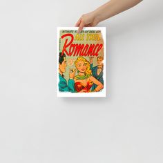 a hand holding up a comic book cover