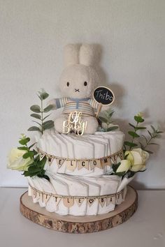 there is a cake that has been decorated with flowers and a teddy bear on top