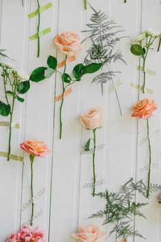 flowers are arranged on the side of a wall