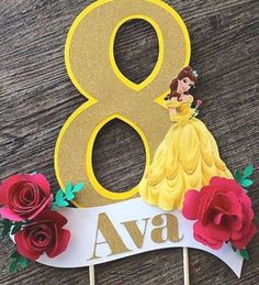 a birthday cake topper with the number 8 on it and flowers around it,