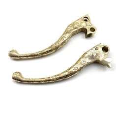 two antique brass door handles on a white background