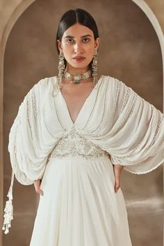 Shop for Seema Thukral Ivory Georgette Draped Bodice Embroidered Gown for Women Online at Aza Fashions Elegant Hand Embellished Wedding Dress With Traditional Drape, White Pre-draped Floor-length Gown, White Embellished Evening Dress For Reception, Evening Dresses With Pearl Embroidery And Cape Sleeves, White Hand Embellished Gown Traditional Drape, White Embellished Gown With Traditional Drape, White Hand-embellished Gown With Traditional Drape, Traditional White Embellished Gown, White Gala Dress With Draped Sleeves