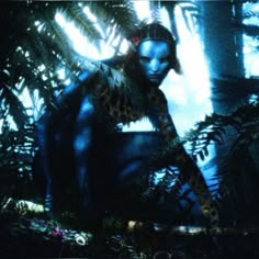 an image of a woman with blue skin and leopard print on her body in the woods