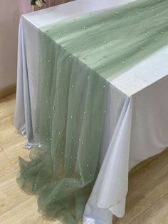 the table is covered with a light green organe and sequins on it