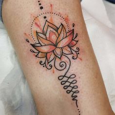 a woman's leg with a tattoo on it that has a flower in the center