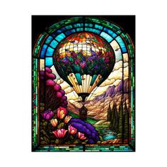 a stained glass window with flowers and a hot air balloon