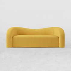 a yellow couch sitting on top of a white floor next to a wall and window