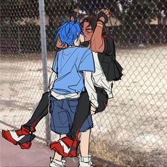 two people hugging each other in front of a chain link fence