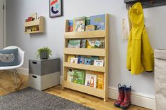 a child's room with bookshelves and toys on the floor in front of it