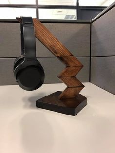 the headphones stand on top of an office desk