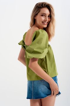 This oversized 100% Cotton poplin top boasts of on-trend balloon sleeves, elasticated trimmings, and a cropped length.  The square neck and back complement the puffy short sleeves and smock aesthetic.  The green hue is trending strong this season, making this the perfect complement to a pair of high-waisted jeans, trousers, or shorts. In our photos, we pair it with our Distressed Hem Denim Mini Skirt, worn untucked for that relaxed aesthetic.  The model is 5�’9” with measurements of 32-24-35 and Short Balloon Sleeves, Green Shirts, Cotton Poplin Top, Green China, Fluffy Sweater, Balloon Sleeve Top, Poplin Top, Sustainable Fabric, Ribbed Midi Dress