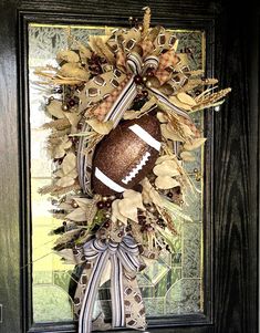 a football wreath is hanging on the front door