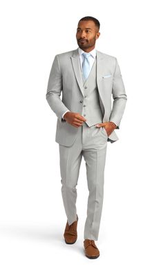 A slim light grey suit with one button and a peak lapel. Gray Notch Lapel Tuxedo, Classic Gray Suit With Single Button, Classic Gray Single Button Suit, Fitted Gray Suit For Wedding, Gray Single Button Semi-formal Suits, Fitted Gray Tuxedo For Groom, Gray Notch Lapel Blazer For Wedding, Gray Fitted Blazer For Wedding, Classic Fitted Gray Tuxedo