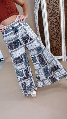 Hit the streets of style wearing these Midnight Daydream Printed Wide leg Pant! With boho designs and wide legs that taper down as you walk, you'll be sure to turn heads no matter the occasion. Make 'em your go-to for a unique look! Boho Pants Wide leg Elastic waistband Flare Flowy fit Measurements: Measured laying flat - 4” stretch in the waistband S: Waist: 26” | Hip: 42” | Rise: 12” | Inseam: 29 1/4” M: Waist: 28” | Hip: 44” | Rise: 12 1/4” | Inseam: 29 3/4” L: Waist: 30” | Hip: 46” | Rise: 12 1/2” | Inseam: 30 1/4” Model Specs: Emily is wearing a size small in the photo. How will this item fit you? Check out our MODEL SPECS(Typical Sizing - Karli: S-Size 5/26 - 5ft 2in, Emily: S-Size 3/25 - 5ft 5in, Syd: L/XL- Size 15/ - 5ft 8in)Need help with sizing? No problem! Join our VIP group on Flowy Boho Print Bottoms For Spring, Hippie Boho Print Vacation Bottoms, Casual Boho Print Wide Leg Harem Pants, Casual Wide Leg Boho Print Harem Pants, Summer Hippie Pants With Boho Print, Summer Boho Print Harem Bottoms, Flowy Casual Bottoms With Boho Print, Boho Print Harem Bottoms For Summer, Boho Print Long Pants For Summer