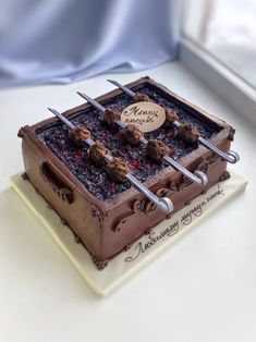 there is a cake that has been made to look like a box with chocolates on it