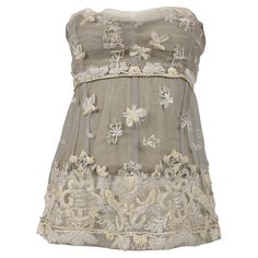 Resurrection Vintage is excited to offer a vintage Dolce & Gabbana lace bustier top featuring dimensional off-white embroidery, corset boning interior, and a zipper down the back. * Dolce & Gabbana * Size: IT42 * Fabric: 10% Cotton, 80% Nylon, 10% Silk, Lining: 66% Cotton, 34% Spandex * 2006 Collection * Excellent Vintage Condition * Authenticity Guaranteed Vintage Dolce And Gabbana, Dolce And Gabbana Aesthetic, 19 Century Dress, Vintage Bustier, Lace Bustier Top, Lacy Tops, Century Dress, 2000s Clothes, Lace Silk