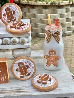 gingerbread cookies decorated with icing and sprinkles sit on a table