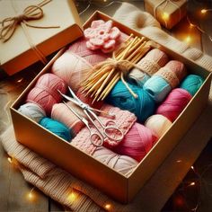 a box filled with lots of yarn and crochet hooks on top of a table