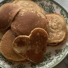 heart shaped pancakes on a green and white plate