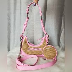 -Pink Fondant Straw/Wicker Crossbody Bag With Pink "Steve Madden" Logo Charm On The Front -Comes With Adjustable/Detachable Crossbody Strap And Has Faux Leather Shoulder Strap (Shoulder Strap Attachment Can Be Taken Off) -Bag Can Be Worn As A Crossbody Bag, Shoulder Bag, Or As A Handbag -Inside Bag Has One Zippered Wall Pocket With One Sleeve Pocket -Zipper Closure -All Silver Hardware Accents -New With Tags. No Damages Dimensions: W:8½" H:4" D:2½" Pink Satchel Baguette Bag With Mobile Phone Holder, Pink Satchel Baguette Bag For Mobile Phone, Casual Pink Baguette Bag For Travel, Pink Shoulder Baguette Bag For Mobile Phones, Trendy Pink Crossbody Baguette Bag, Pink Crossbody Baguette Bag With Mobile Phone Pocket, Pink Crossbody Baguette Bag With Mobile Phone Bag, Pink Crossbody Baguette Bag With Detachable Handle, Pink Crossbody Baguette Bag With Detachable Strap