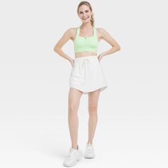 Why we're ALL IN: Woven mid-rise skort with built-in shorts in a regular-fit silhouette makes a cool choice for your active days. Moisture-wicking, quick-dry lightweight fabric helps you stay cool, while a drawcord elastic waistband provides a snug fit. Side pocket provides hands-free convenience and the UPF 50+ rating offers sun protection. All in Motion™: Made for every move, priced for every day. Spring Athletic Shorts With Built-in Shorts, Above Knee, Functional Summer Tennis Skirt With Built-in Shorts, Functional Tennis Skirt For Summer Gym, Functional Skort For Summer Gym, Functional Summer Gym Skort, Sporty Above Knee Activewear For Summer, Green Athleisure Tennis Skirt, Casual Green Skort For Gym, Spring Tennis Skirt With Moisture-wicking