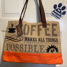 an orange and brown bag hanging on a door with a dog paw sticker next to it