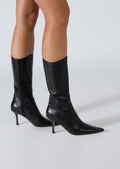 Sheba has a pointed toe and slender heel, creating a sleek silhouette, exuding timeless grace. The distinctive curved opening adds a touch of modernity, making these boots a stand out choice for any occasion. Crafted with precision and style, these calf boots will effortlessly elevate your look. -Material: Leather -Sole: Man-Made -Fit: True to Size -Toe-shape: Point -Features: Curved Opening -Heel: 8cm Leg Height x Calf Circumference x Opening Circumference 5 - 269mm x 318mm x 318mm 5.5 - 273mm Point Toed Boots, Pointed Boots Outfit, Mid Calf Boots Outfit, Calf Boots Outfit, Black Stiletto Boots, Black Boot Heels, Heels Boots Outfit, Boots Aesthetic, Pointy Boots