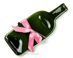 a green bottle with a red ribbon tied around it