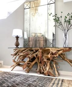 a table made out of driftwood and mirrors