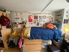 a bed room with a neatly made bed and lots of clutter