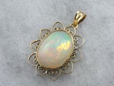 This Mid Century, simple pendant is a great frame for the outstanding Ethiopian Opal gem that we've set at the center. This is a wonderful stone, filled not only with greens and oranges, but also with a rare, pink glow at the center! The radiant style of the frame certainly brings out the glow of the opal! This pendant does not come with the chain shown. Please feel free to contact us, we will help you find the perfect chain for your style and budget! Metal: 14K Yellow Gold Gem: Ethiopian Opal 8 Simple Pendant, The Glow, Opal Pendants, Opal Jewelry, Oval Cabochon, Jewelry Lover, Eternity Bands, Ethiopian Opal, Locket