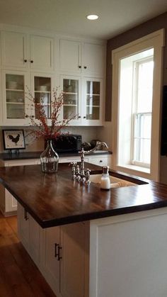 a kitchen with white cabinets and black counter tops, has the words amazing kitchen remodel for under $ 650