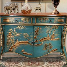 an ornately decorated blue and gold dresser