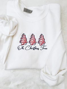 Oh Christmas Tree cake  sweatshirt ,    This is embroidered design onto white color sweatshirt ! -Material is 50%cotton and 50%polyester. -This is unisex fitting sweatshirt:Size chart is listed in images! -FYI:I do rotate sweatshirt brands based on size and availability in stock. Measurements,quality and fitting is equal to one another! -Size up for "oversize" look if desired ! **Shirt is made to order, and processing times is estimated 5-7 business days!  *Due to nature of Handmade goods this o Christmas White Embroidered Tops, White Tops With Custom Embroidery For Christmas, White Cotton Christmas Sweatshirt, White Christmas Tops With Embroidered Graphics, Embroidered White Sweatshirt For Gift, White Top With Embroidered Logo For Christmas, White Tops With Embroidered Logo For Christmas, Christmas Cotton Sweatshirt With Embroidered Logo, White Sweatshirt With Letter Embroidery As Gift