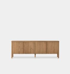 the sideboard with three doors and two drawers, in oak wood finish on an isolated white background