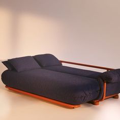 a blue couch sitting on top of a wooden frame