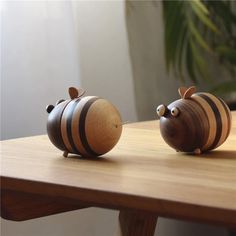 two wooden figurines sitting on top of a table