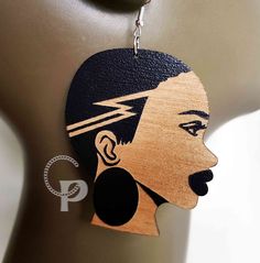 A pair of wooden earrings in a choice of sizes. African woman silhouette in black engraved wood. This item is designed by Custom Pieces and is a subject to copyrights. Made of 3mm thick birch plywood. The design is on both sides. All findings are silver plated and nickel free Made in EU These were laser cut and engraved by us. Size is approximate measured in the wider point. If you require different colour or size than one presented in the photo, please contact me for availability. Free postage Black Laser Cut Jewelry, Natural Hair Undercut, African Woman Silhouette, Afro Silhouette, Woman Afro, Hair Undercut, Laser Cut Jewelry, African Earrings, Wooden Shapes